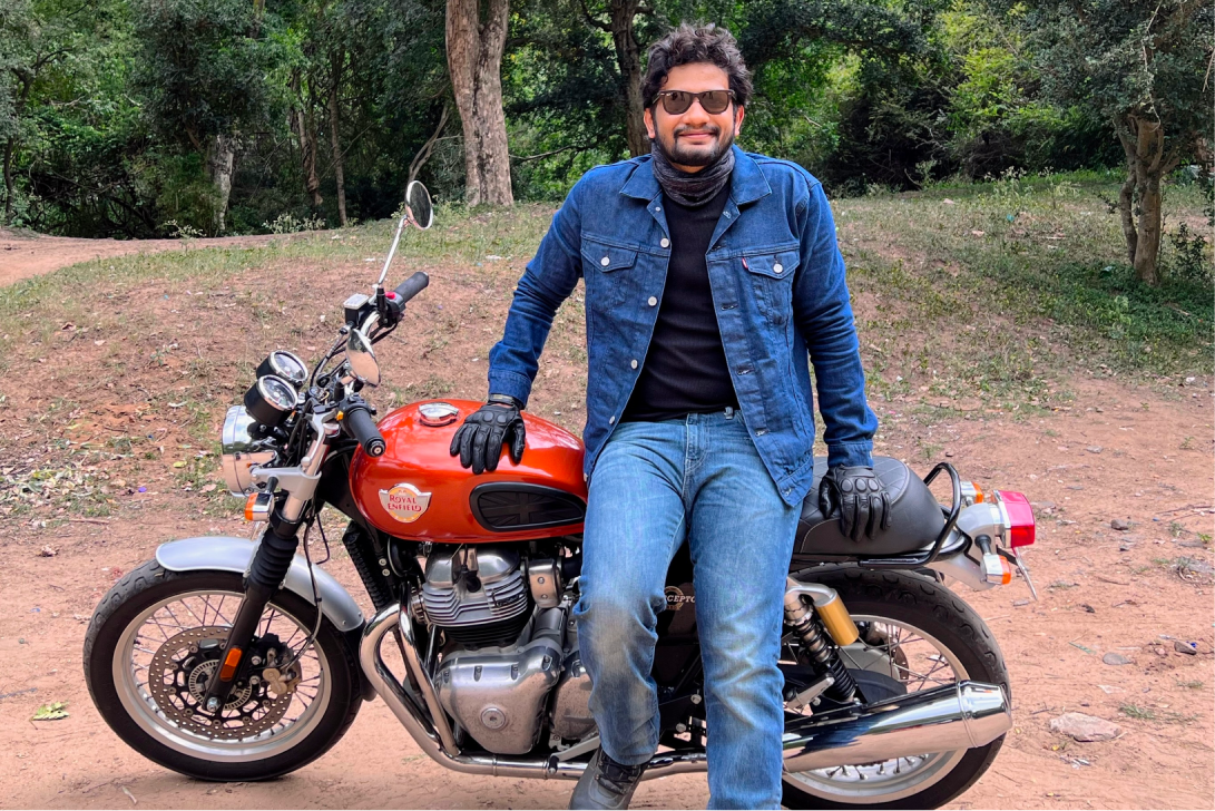 me wearing a denim jacket in front of my royal enfield interceptor 650