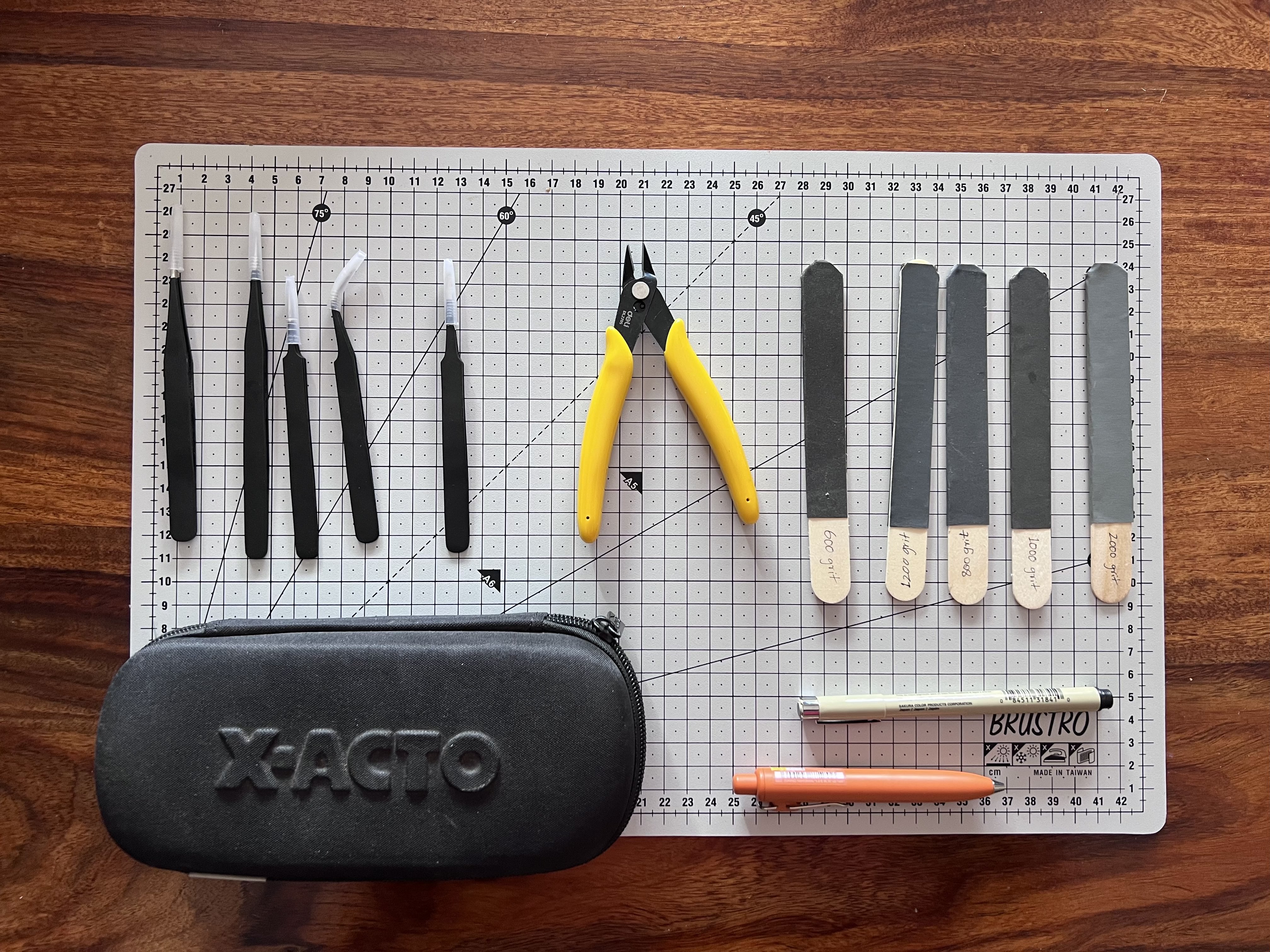 An image of all the tools used in the build kept on top of a cutting mat