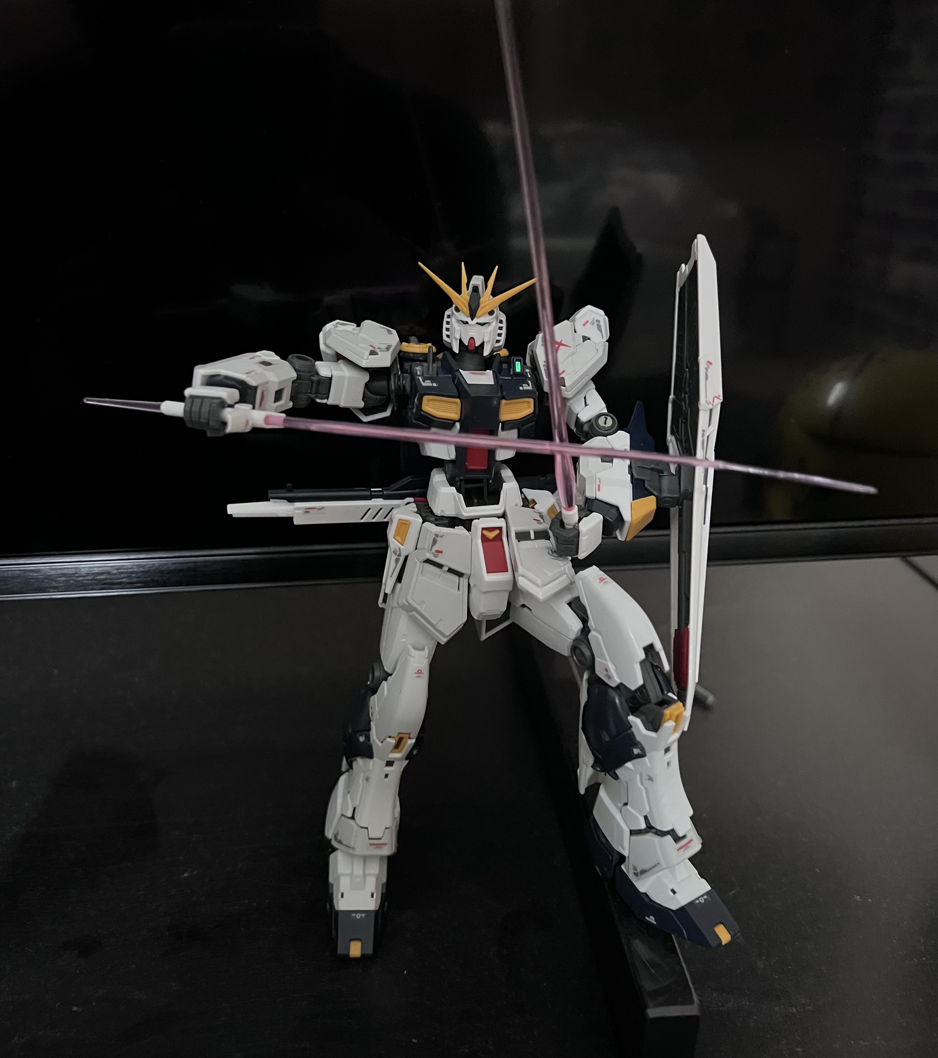 Gundam posing with two sabers crossing each other perpendicularly