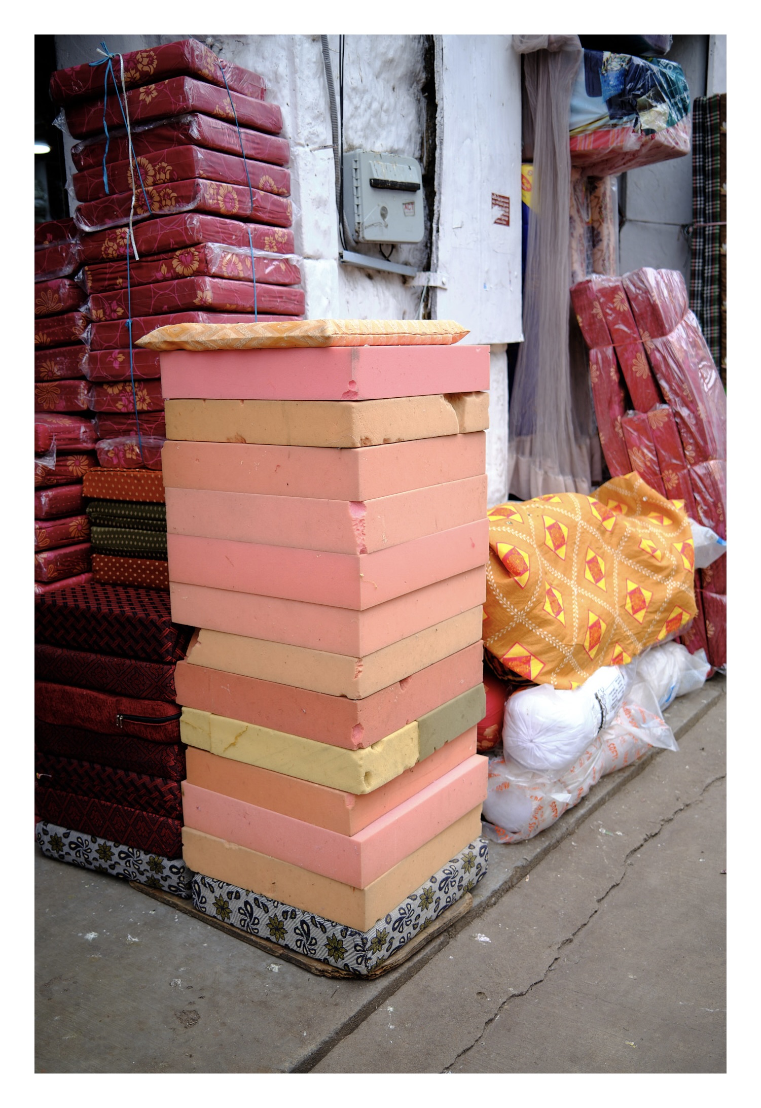 stack of sponges in front of a furniture stores which makes sofas