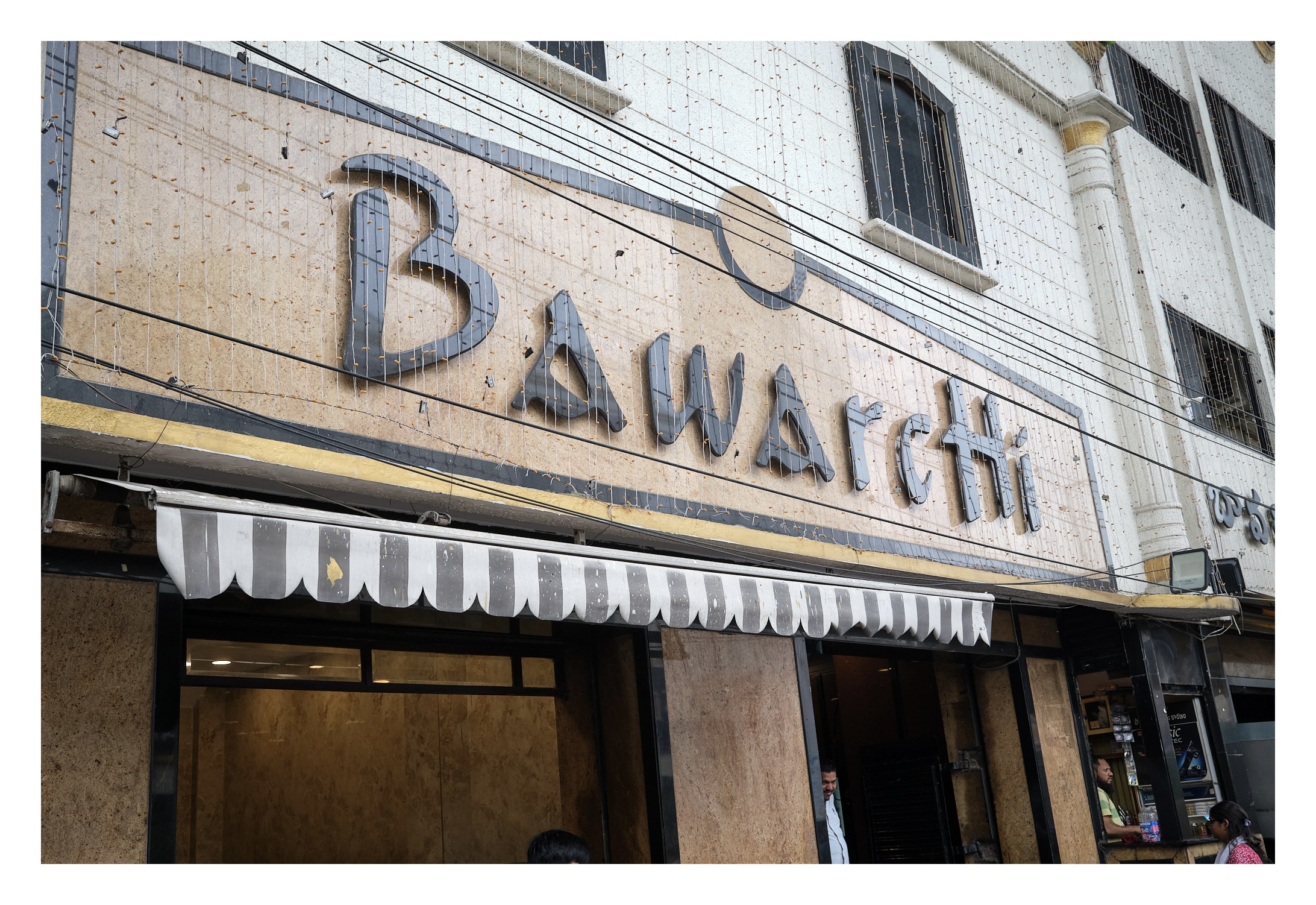 Bawrchi store front which reach 'BawarcHi' on top of a granite Stone