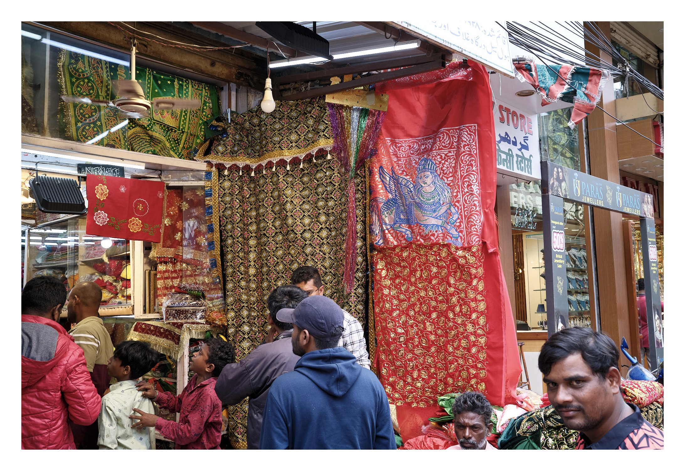 photo of clothes and fabric with sheen from a store near Charminar