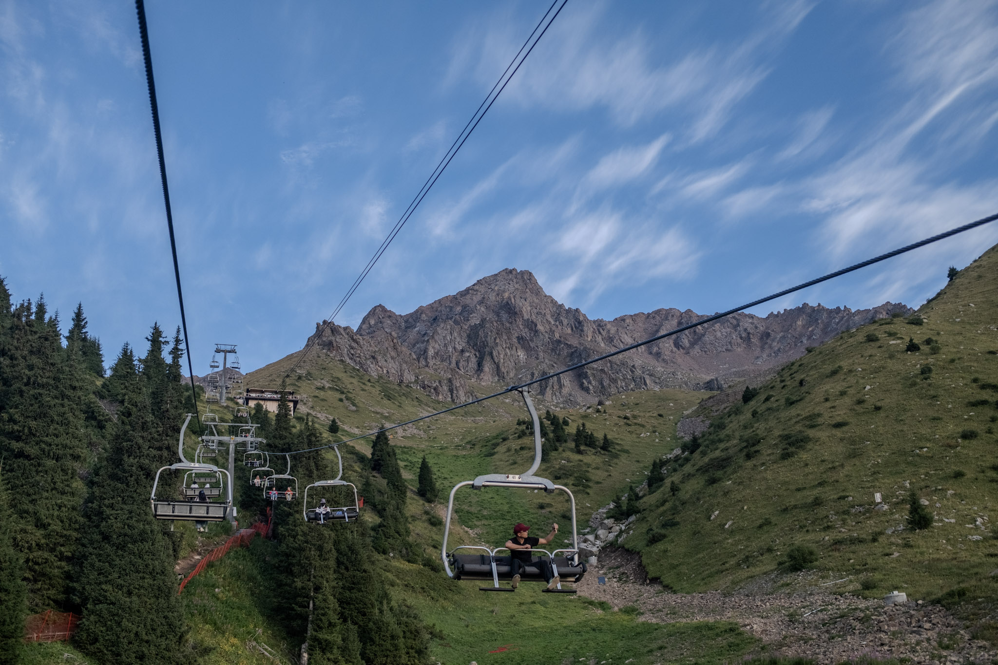 chair lift with a mountian in the background and blue sky