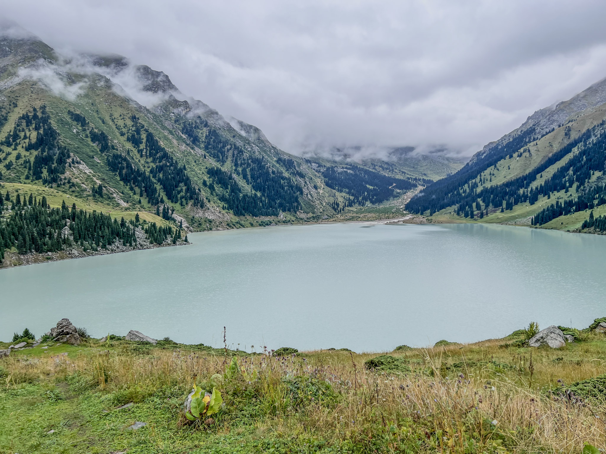 lake with clounds and mountain in the background