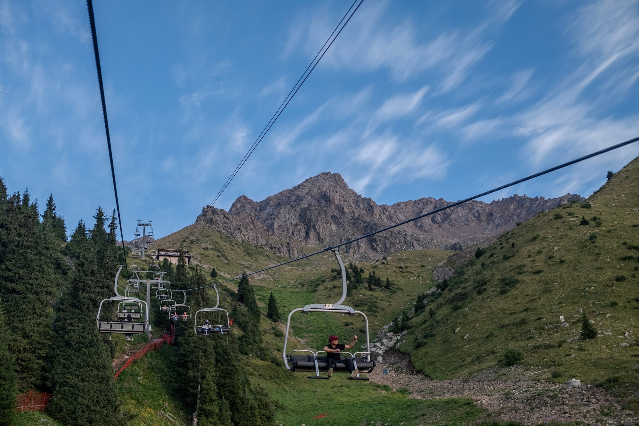 chair lift with a mountian in the background and blue sky