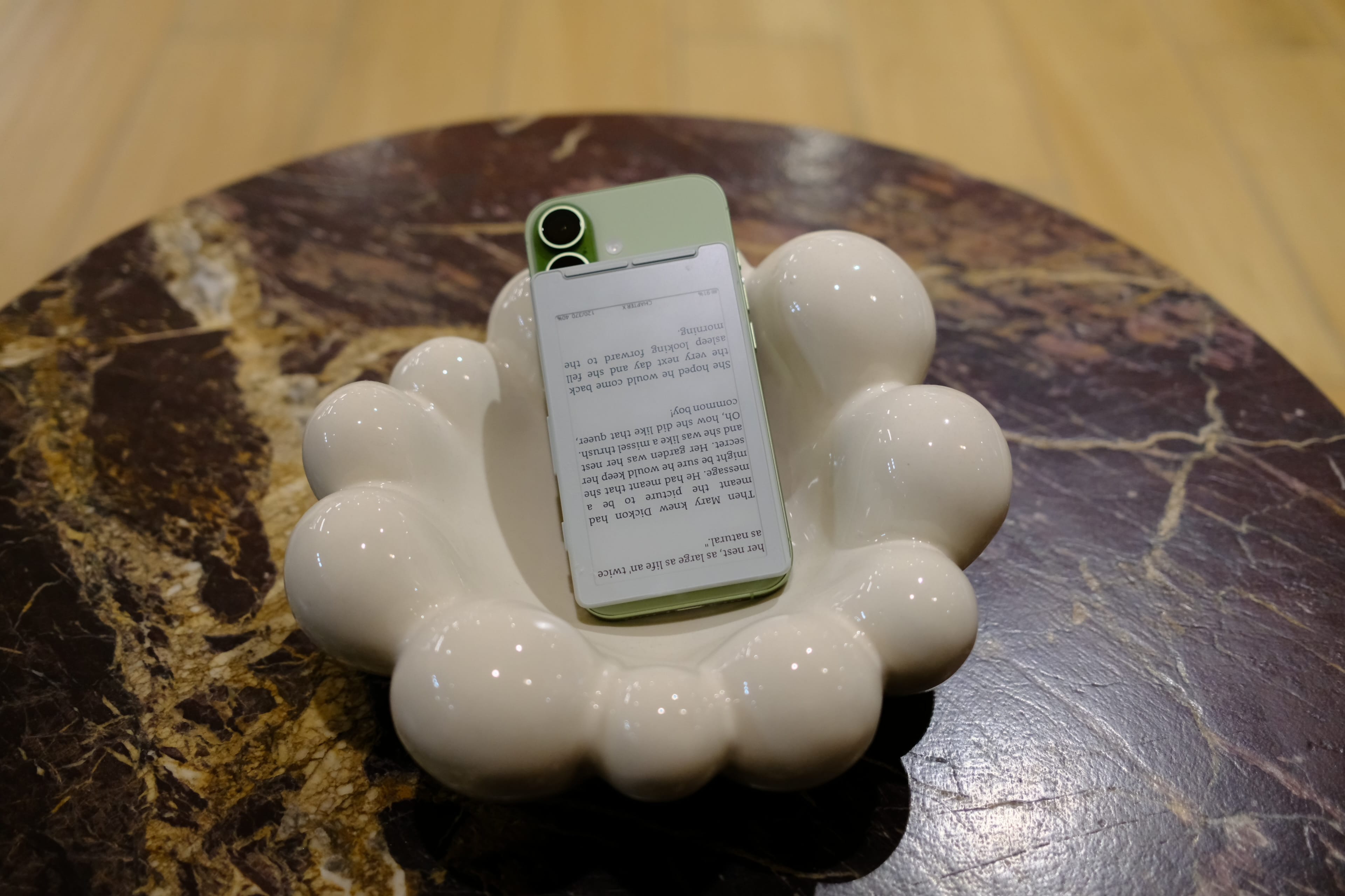 Xteink x4 attached to an iPhone, showing reversed mounting due to smaller form factor