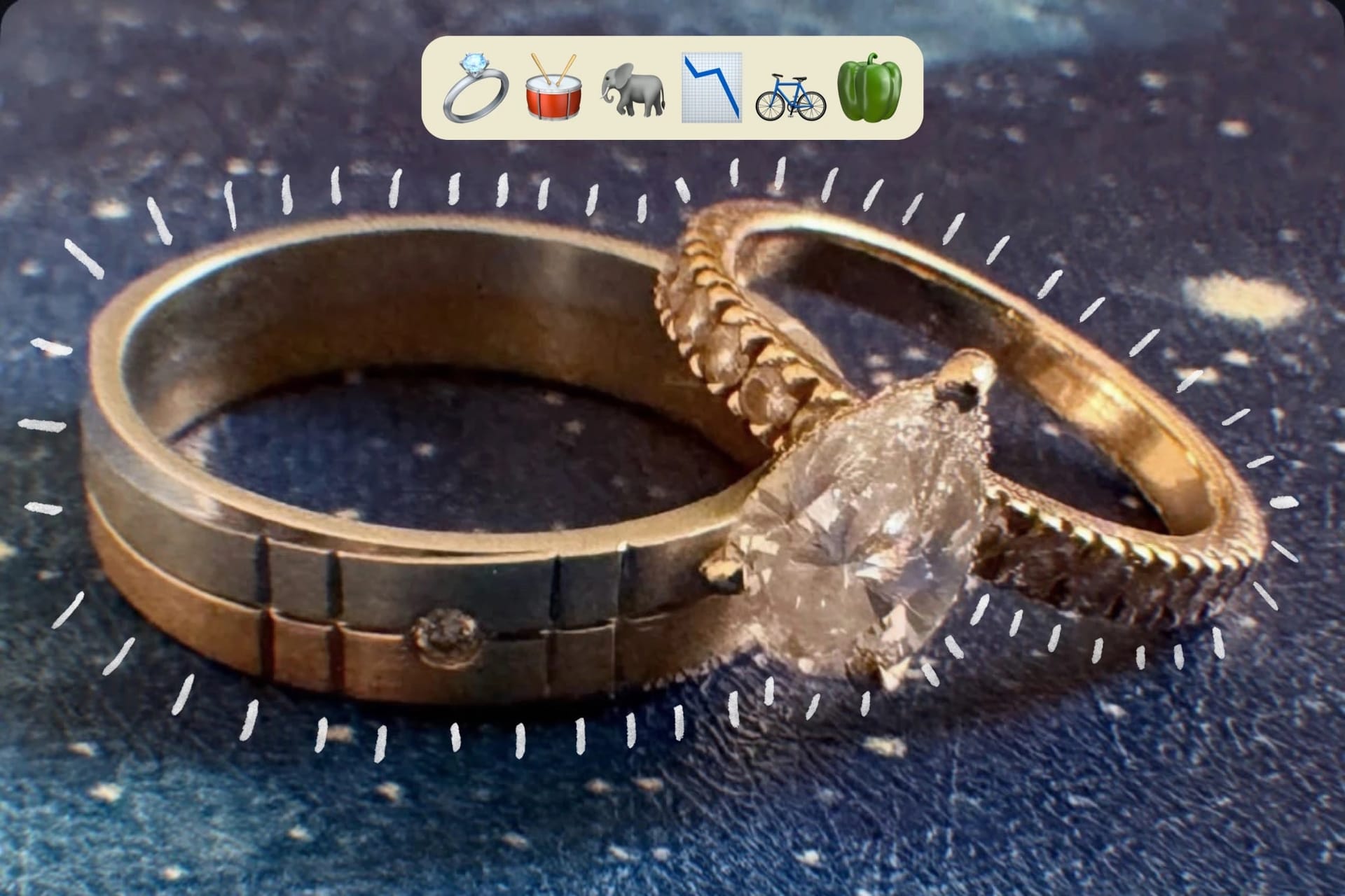 Two wedding rings on a starry dark blue surface, under a row of emojis for a ring, a drum, an elephant, a falling chart, a bicycle and a capsicum